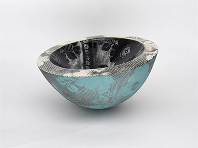 A ceramic bowl with lace patterns on it