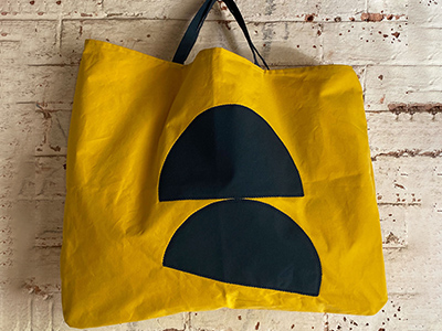 Yellow tote bag with jaunty black semicircles 