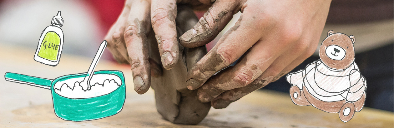 Child's hand playing with clay