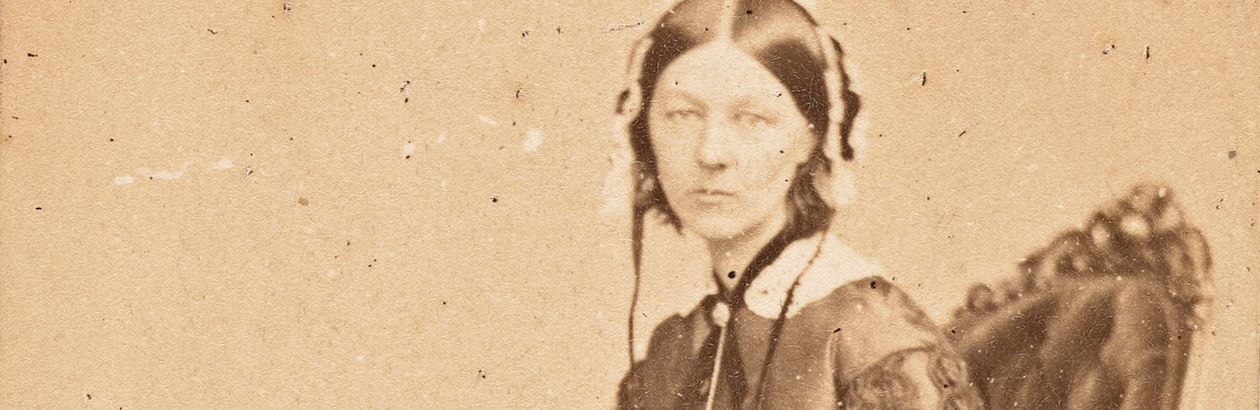 Photograph of seated Florence Nightingale on brown background
