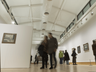 Visitors enjoy the Lowry exhibition in the Djanogly Gallery