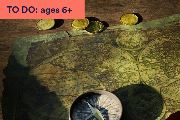 Photograph of old map on table with compass and gold coins. Keywords in corner: TO DO: ages 6+